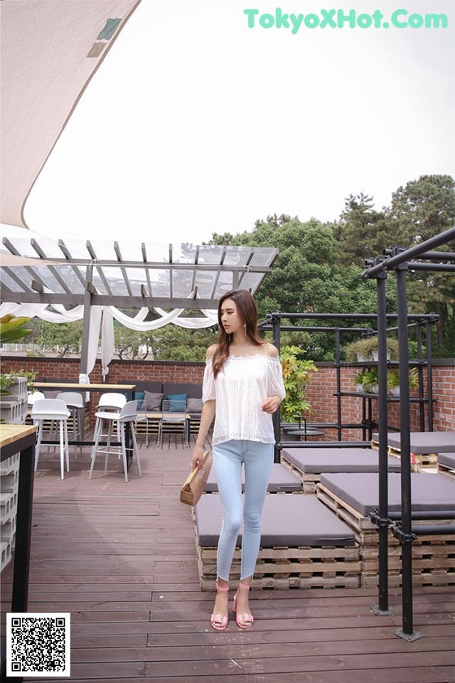 A woman standing on top of a wooden deck.